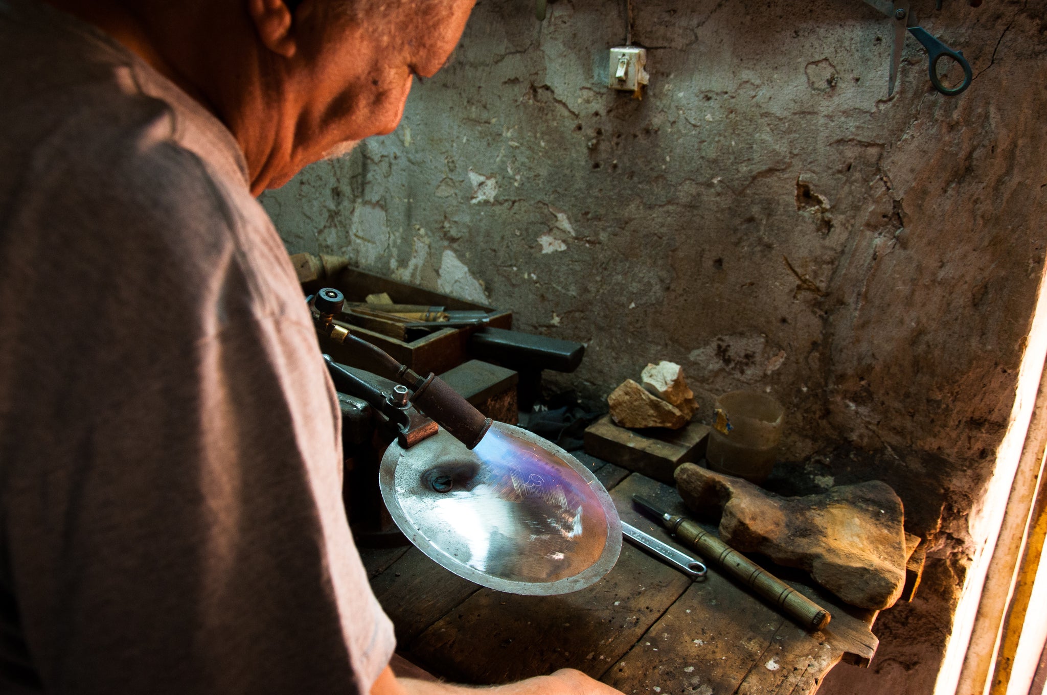 Damascene Artisan using blow torch to melt silver