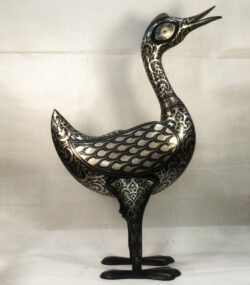 Handmade Moroccan Damascene crane sculpture featuring intricate silver inlay, crafted by master artisans in Meknes. Luxury artisan home décor and collectible metal bird artwork.