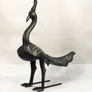Handmade Moroccan Damascene peacock sculpture featuring traditional silver inlay, handcrafted by master artisans in Meknes. Luxury artisan bird decor