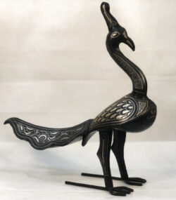 Handmade Moroccan Damascene peacock sculpture featuring traditional silver inlay, handcrafted by master artisans in Meknes. Luxury artisan bird decor